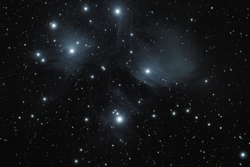 A photo of dust in the Pleiades star cluster.